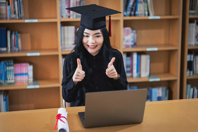 Portrait of smiling young woman reading book