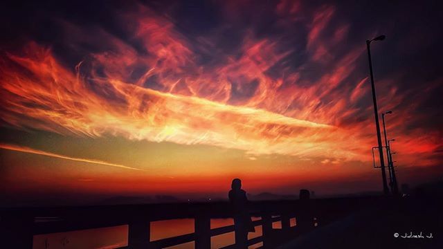 sunset, silhouette, sky, orange color, railing, cloud - sky, dramatic sky, beauty in nature, scenics, nature, cloudy, tranquility, dusk, cloud, tranquil scene, outdoors, idyllic, low angle view, outline