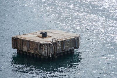 High angle view of bird perching on sea