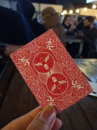 Close-up of hand holding red umbrella