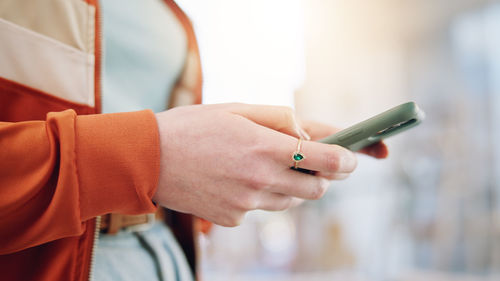 Midsection of man using mobile phone