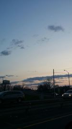 Cars on road at sunset