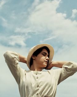 Side view of man standing against sky during sunset