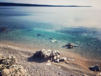 High angle view of rocks on beach against sky