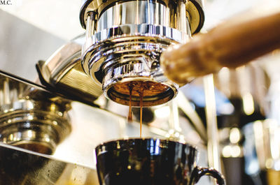 Close-up of coffee preparation in cafe