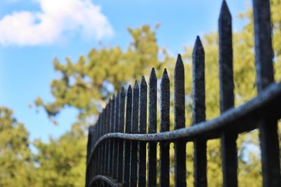 Close-up of metal fence against sky