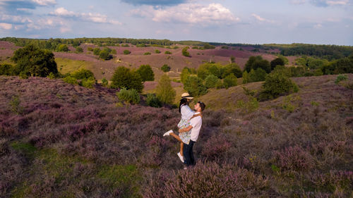 Rear view of woman standing on mountain