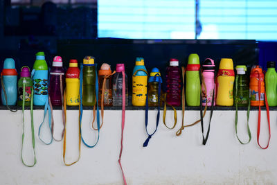 Close-up of multi colored bottles on rack