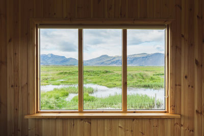 Scenic view of landscape seen through window