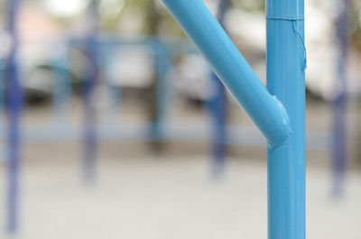 Close-up of metal pole against blue sky