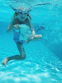 Girl with toy swimming in pool