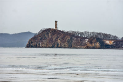 Scenic view of sea against sky during winter