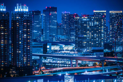 Illuminated modern buildings in city at night