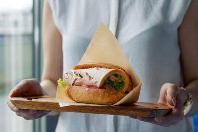 Close-up of hands holding sandwich