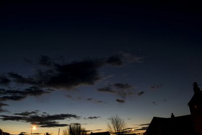 Low angle view of built structure against sky at sunset