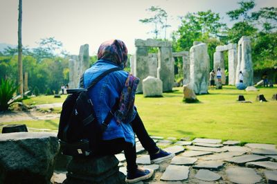 Rear view of man standing against trees