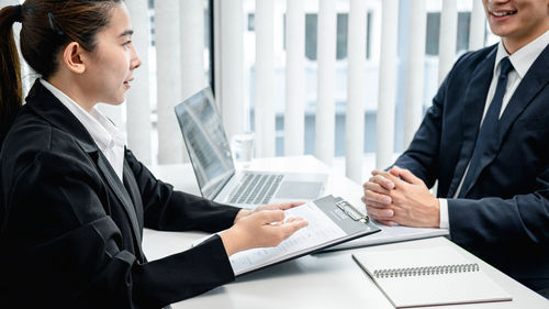 Businessmen shaking hands at office