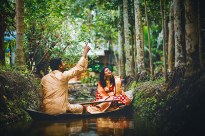 Couple in a boat at clear water canal