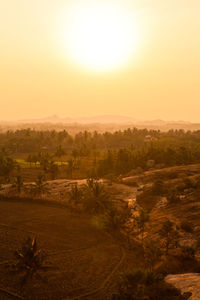 Scenic view of field against sky during sunset