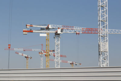 Low angle view of crane against clear sky