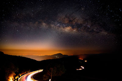 Scenic view of mountains against sky at night