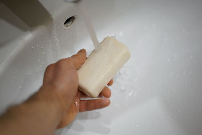 Close-up of person holding hands in bathroom