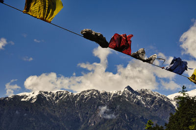 Low angle view of snowcapped mountain against sky