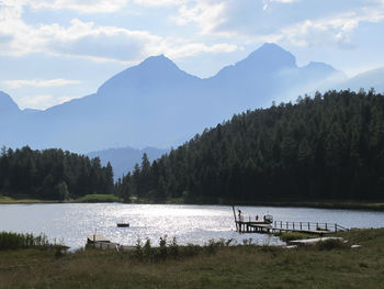 Scenic view of lake and mountains against sky