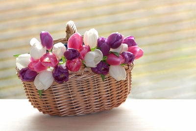 Close-up of pink flowers in basket on table