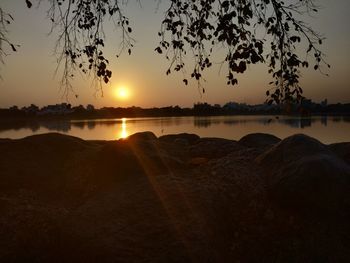 Scenic view of lake against sky during sunset