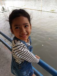 Portrait of smiling boy standing in water