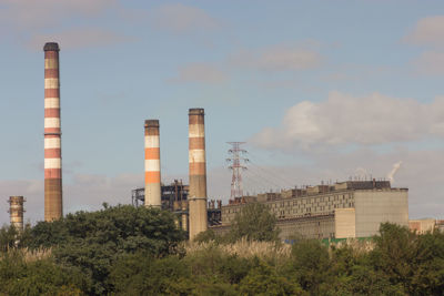 Low angle view of factory against sky