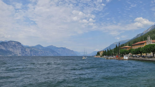 Sailboats in sea against sky