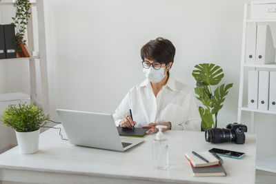 Young woman using laptop on table