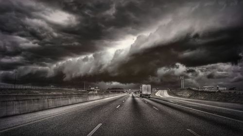 Storm clouds over highway during sunset