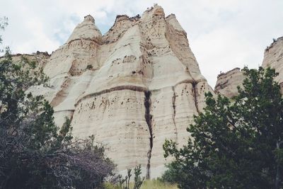 Low angle view of rocky mountain against sky