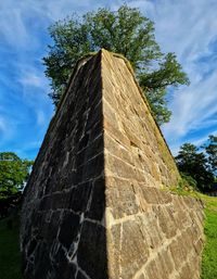 Low angle view of stone structure against sky