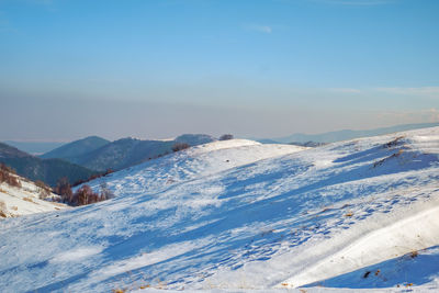 Sun over the winter mountains with snow, cindrel mountains, paltinis, romania