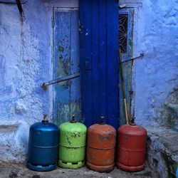 Gas cylinders against old wooden door