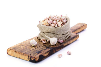 High angle view of bread on cutting board against white background