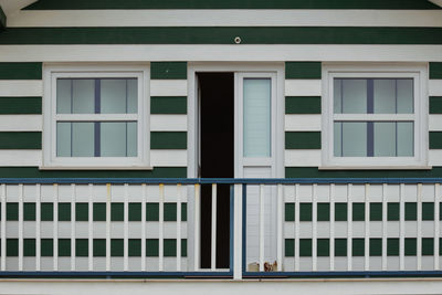 Typical colourful houses with green and white stripes in costa nova - aveiro against sky