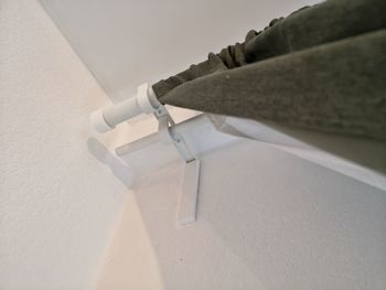 High angle view of paper on table against white wall