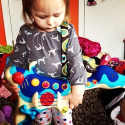 Portrait of girl playing with toy