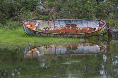 Abandoned boat in lake