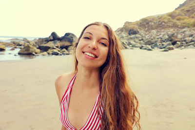 Portrait of smiling young woman on beach