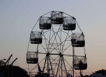 Low angle view of ferris wheel against sky