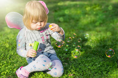 Cute boy playing with grass