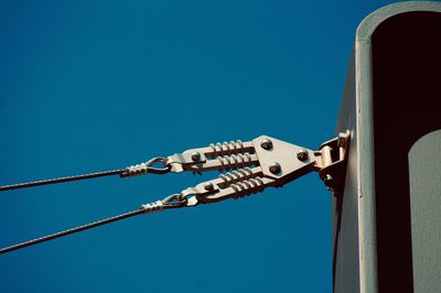 Low angle view of pole against clear blue sky