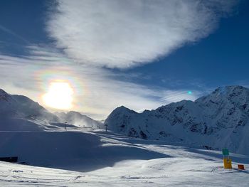 Scenic view of snowcapped mountains against sky