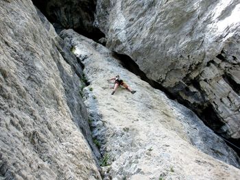 Man on rock formation in mountains